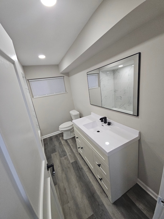 bathroom with hardwood / wood-style flooring, vanity, and toilet