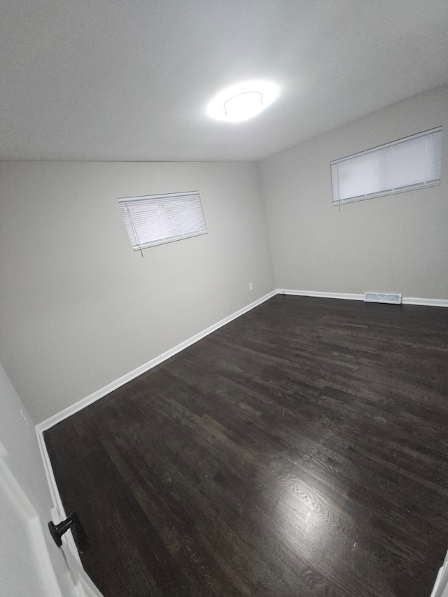 empty room with dark hardwood / wood-style floors