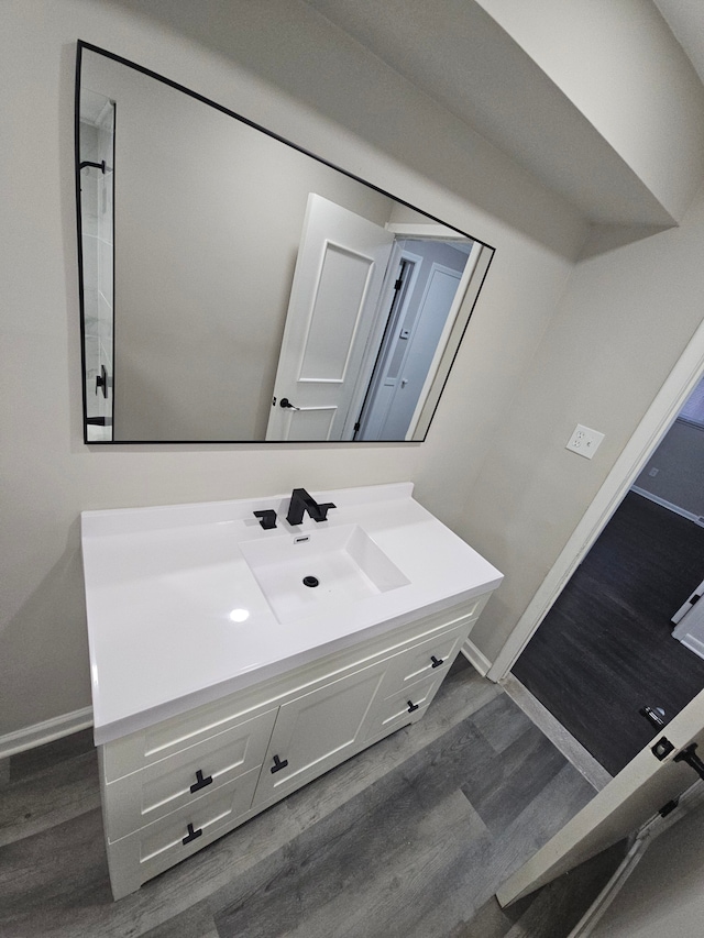 bathroom with hardwood / wood-style floors and vanity