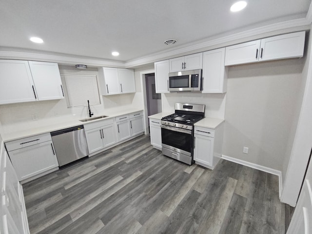 kitchen featuring white cabinets, crown molding, sink, and stainless steel appliances