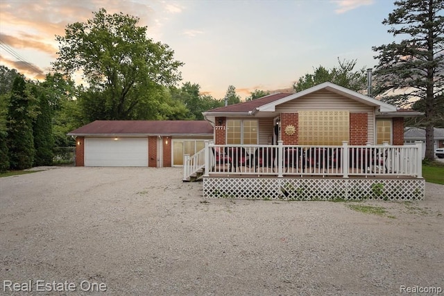 ranch-style house with covered porch and a garage