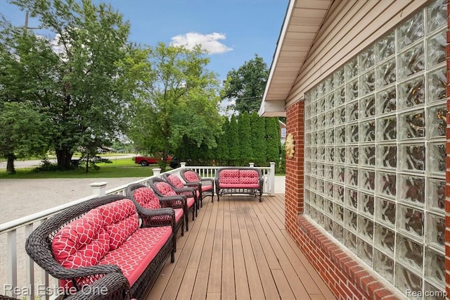 wooden terrace with outdoor lounge area