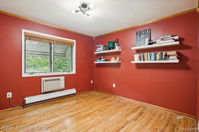 unfurnished room featuring hardwood / wood-style flooring, ornamental molding, an AC wall unit, and a baseboard heating unit