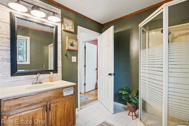 bathroom featuring vanity, tile patterned floors, walk in shower, and crown molding