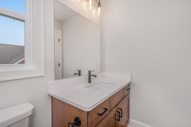 bathroom featuring vanity and toilet