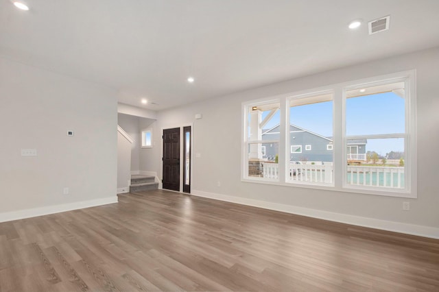 unfurnished living room with hardwood / wood-style floors