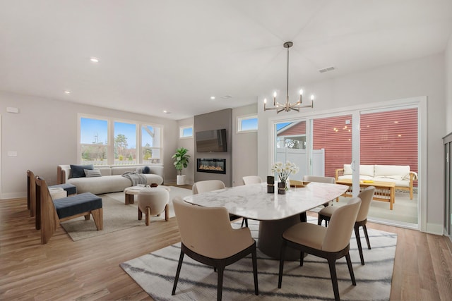 dining space featuring a chandelier and light wood-type flooring