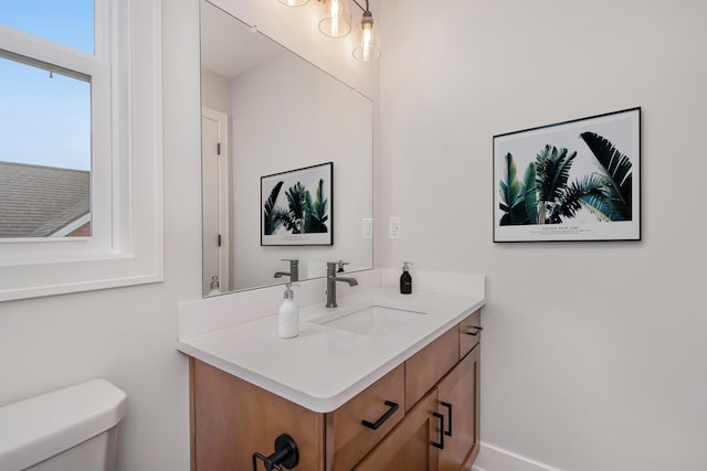 bathroom featuring vanity and toilet