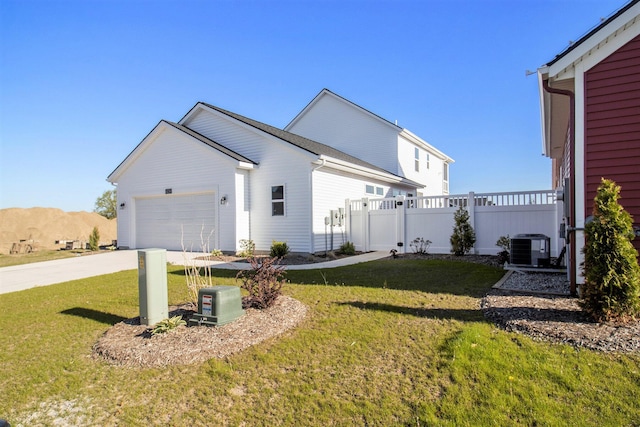 14236 Phoenix Pl, Holland, MI 49424 - view of side of home with a garage, central air condition unit, and driveway