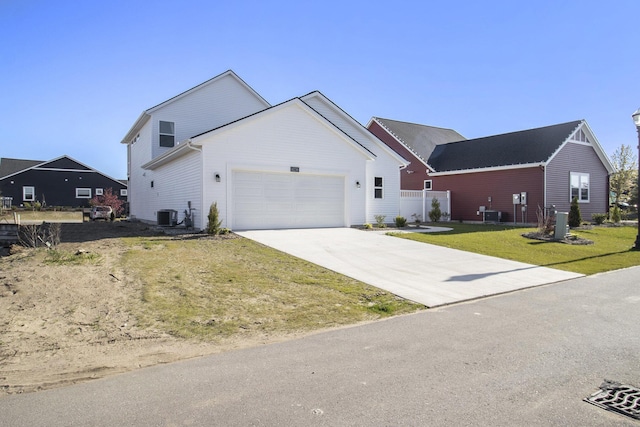14236 Phoenix Pl, Holland, MI 49424 - view of front of property featuring an attached garage, concrete driveway, and central air condition unit