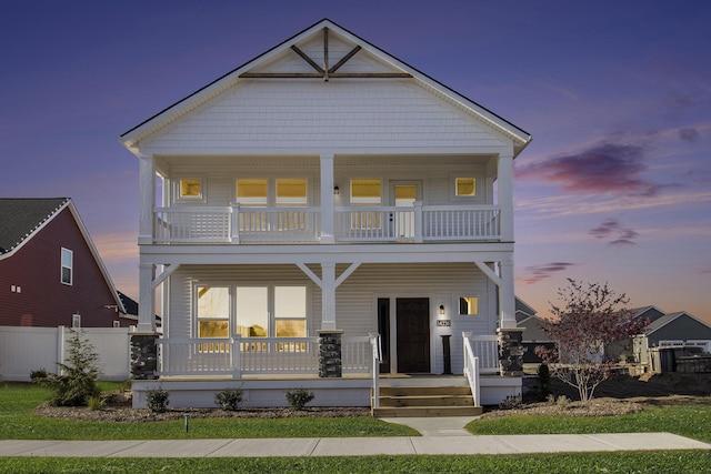 14236 Phoenix Pl, Holland, MI 49424 - view of front facade featuring a balcony, covered porch, and fence