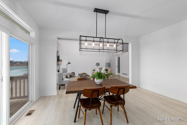 dining room with visible vents and light wood finished floors