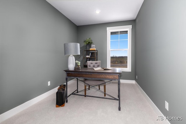 carpeted office featuring baseboards