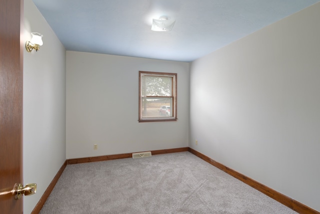 unfurnished room with light carpet