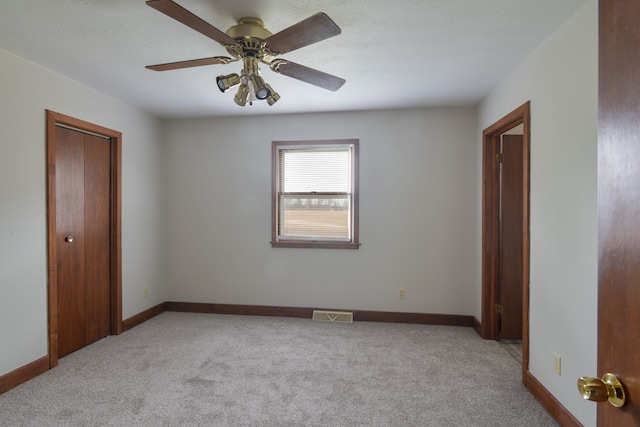 unfurnished bedroom with light carpet and ceiling fan