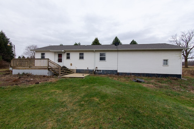 back of house featuring a deck and a yard