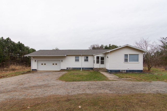 ranch-style house featuring a front yard and a garage