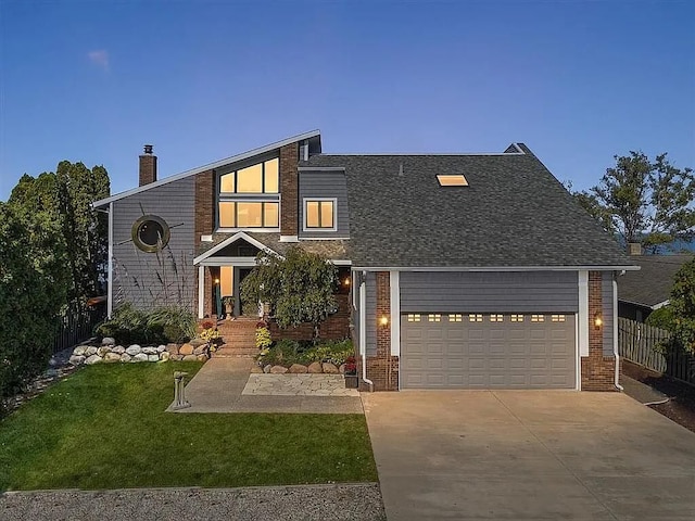 view of front of home with a front yard and a garage