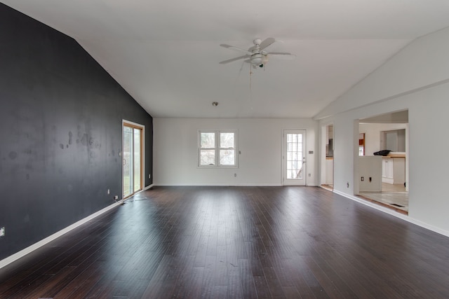 spare room with dark hardwood / wood-style floors, ceiling fan, and lofted ceiling