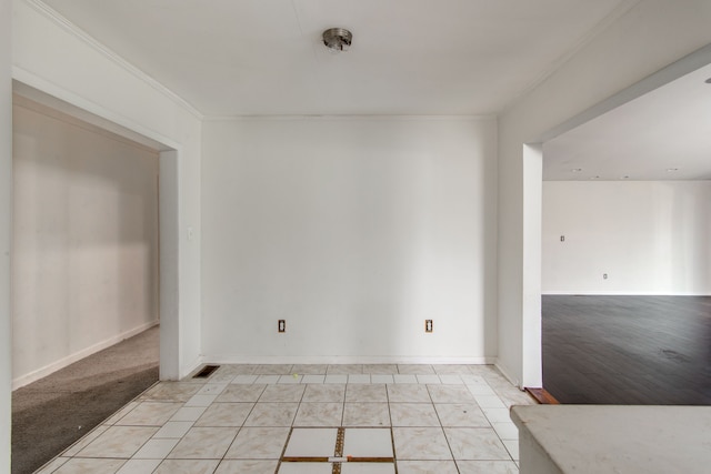 unfurnished room with light carpet and crown molding