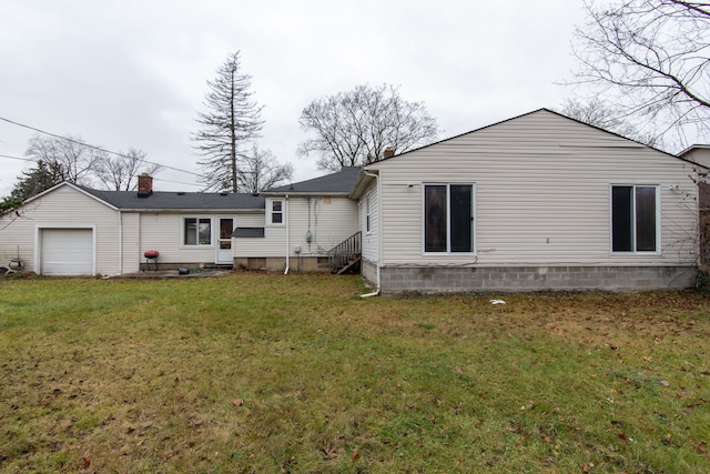 back of property with a yard and a garage