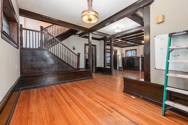 entrance foyer featuring beamed ceiling, wood-type flooring, and coffered ceiling