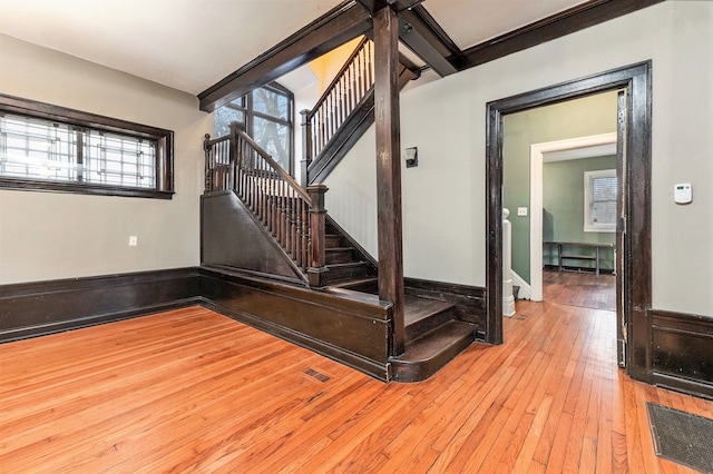 stairs featuring hardwood / wood-style floors