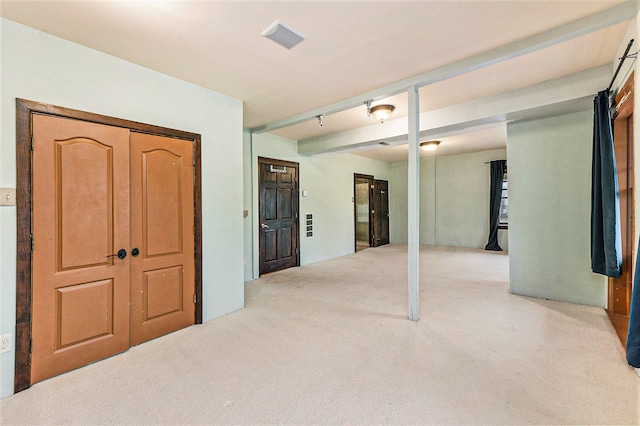 basement featuring light colored carpet