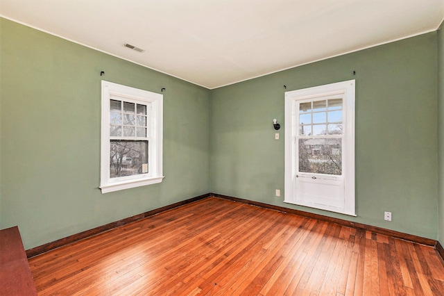 spare room featuring wood-type flooring