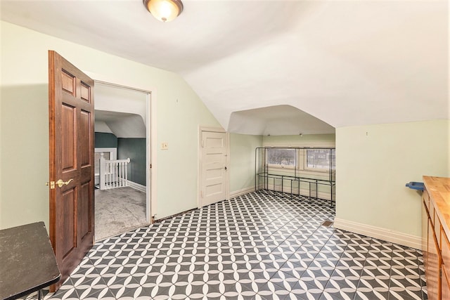 additional living space featuring carpet and vaulted ceiling