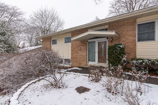 44080 Marlson Ave, Novi, MI 48375 - snow covered property entrance with brick siding