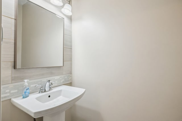 bathroom featuring backsplash and sink