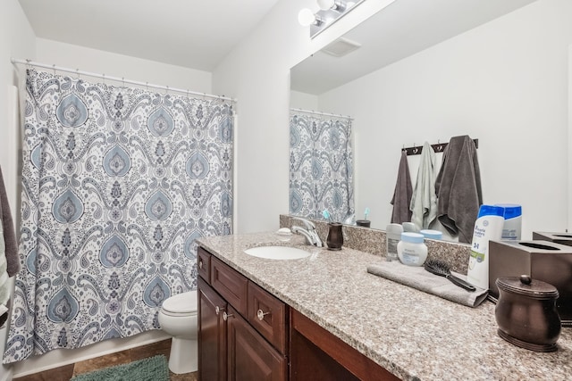 bathroom featuring tile patterned flooring, vanity, and toilet