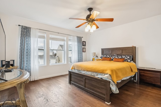 bedroom with ceiling fan and dark hardwood / wood-style flooring