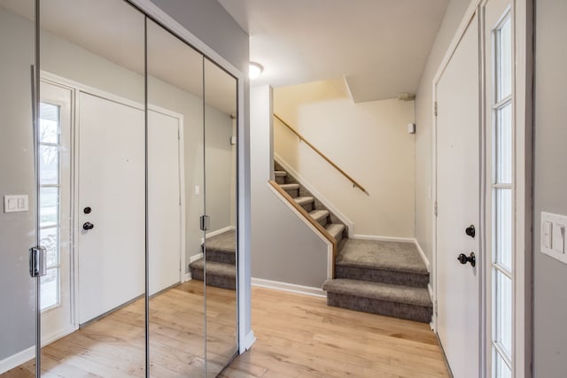 foyer entrance with light hardwood / wood-style floors and plenty of natural light