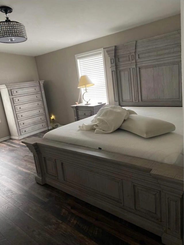 bedroom with dark hardwood / wood-style flooring