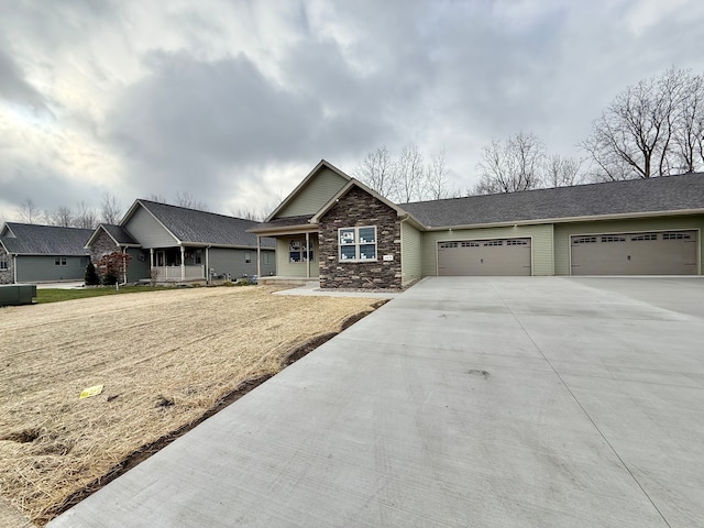 craftsman-style house with an attached garage, driveway, and a front lawn