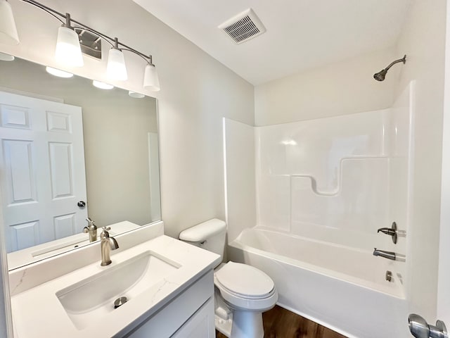 full bathroom with vanity, toilet, wood-type flooring, and tub / shower combination