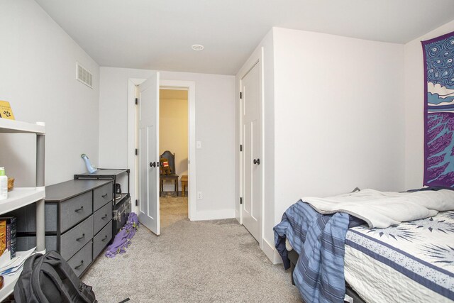 bedroom featuring light colored carpet