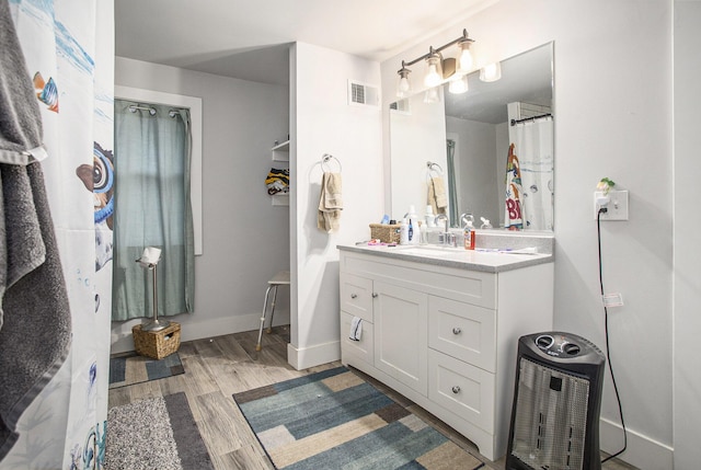 bathroom featuring hardwood / wood-style floors and vanity