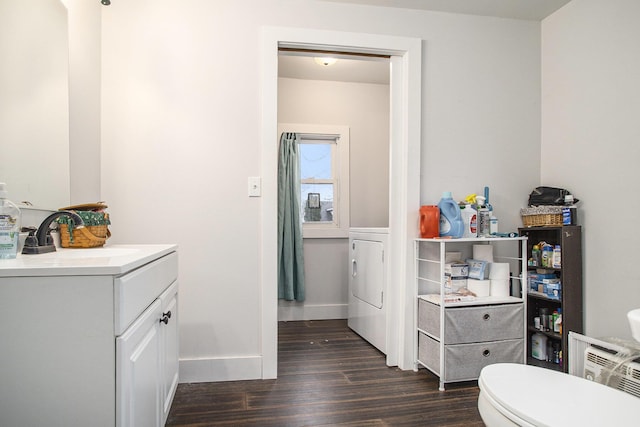 bathroom featuring wood-type flooring, vanity, washer / clothes dryer, and toilet