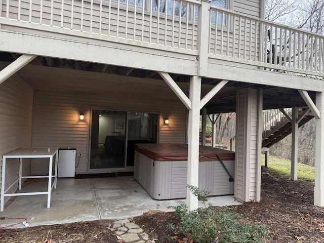 view of patio / terrace featuring a wooden deck and a hot tub