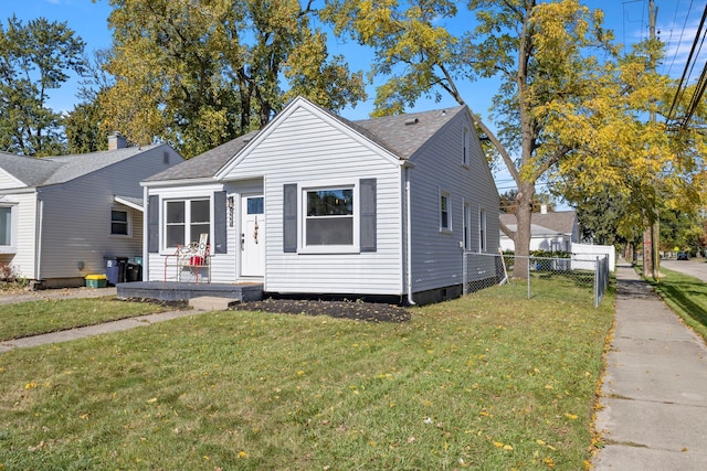 bungalow-style house with a front lawn