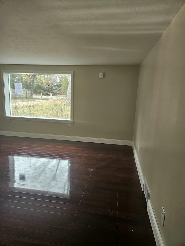 unfurnished room featuring dark hardwood / wood-style floors