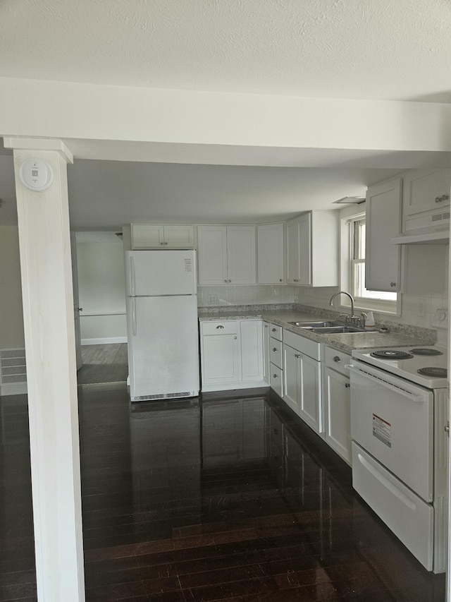 kitchen with white cabinetry, dark hardwood / wood-style flooring, and white appliances