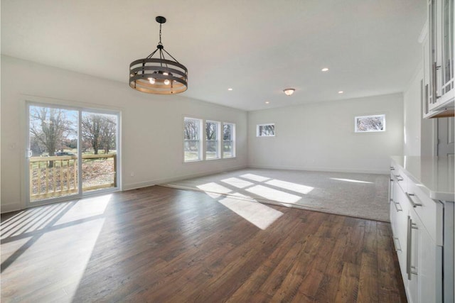 interior space with an inviting chandelier, recessed lighting, dark wood-style floors, and baseboards