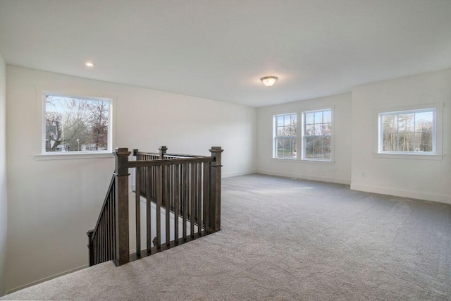 carpeted empty room featuring recessed lighting and baseboards