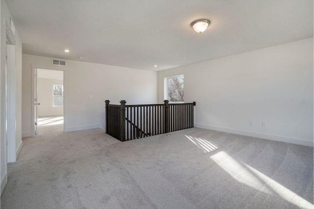 spare room with recessed lighting, visible vents, carpet flooring, and baseboards