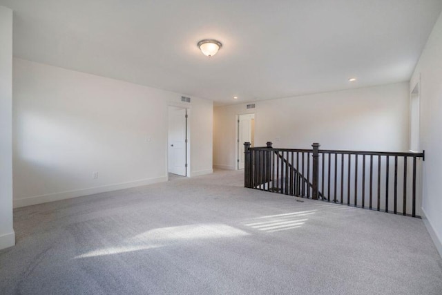 empty room featuring visible vents, recessed lighting, baseboards, and carpet floors