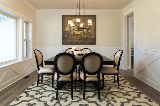 dining space with a chandelier, visible vents, dark wood finished floors, and crown molding